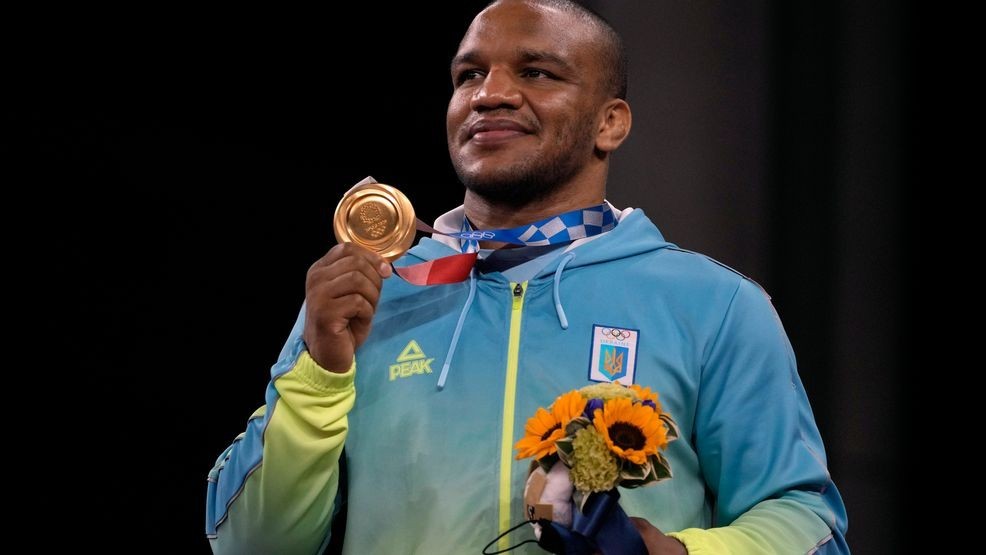 FILE - Gold medalist, Zhan Beleniuk of Ukraine, celebrates on the podium during the medal ceremony for the men's 87kg Greco-Roman wrestling at the 2020 Summer Olympics, Wednesday, Aug. 4, 2021, in Chiba, Japan. (AP Photo/Aaron Favila, File)