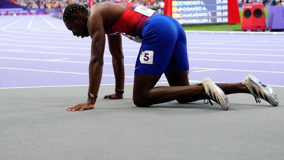 Noah Lyles, of the United States, rests on the track following the men's 200-meters final at the 2024 Summer Olympics, Thursday, Aug. 8, 2024, in Saint-Denis, France.(AP Photo/Petr David Josek)