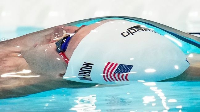 Ryan Murphy, of the United States, competes during a heat in the men's 100-meter backstroke at the 2024 Summer Olympics, Sunday, July 28, 2024, in Nanterre, France. (AP Photo/Bernat Armangue)