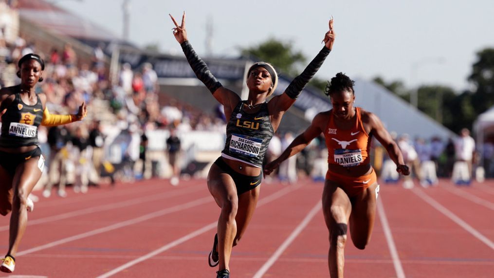 FILE - LSU's Sha'Carri Richardson, center, celebrates as she wins the women's 100 meters during the NCAA outdoor track and field championships in Austin, Texas, June 8, 2019. (AP Photo/Eric Gay, File)