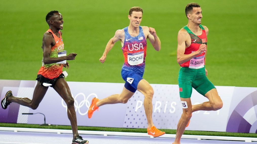 Soufiane El Bakkali, of Morocco, right, Kenneth Rooks, of the United States, center, and Abraham Kibiwot, of Kenya, competes in the men's 3000-meters steeplechase final at the 2024 Summer Olympics, Wednesday, Aug. 7, 2024, in Saint-Denis, France. (AP Photo/Natacha Pisarenko)