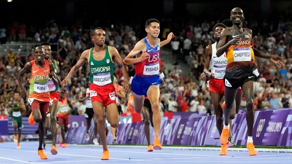 Joshua Cheptegei, of Uganda, celebrates after winning the men's 10,000-meter final at the 2024 Summer Olympics, Friday, Aug. 2, 2024, in Saint-Denis, France. (AP Photo/David J. Phillip)